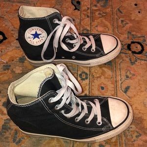 Black wedge converse shoes.